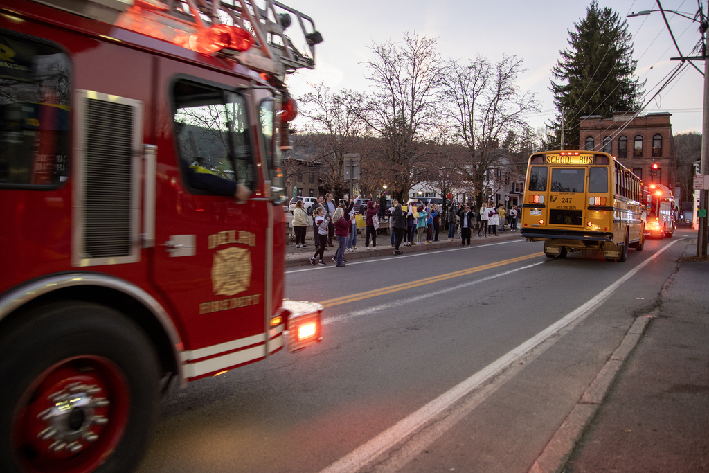 people cheer the school bus