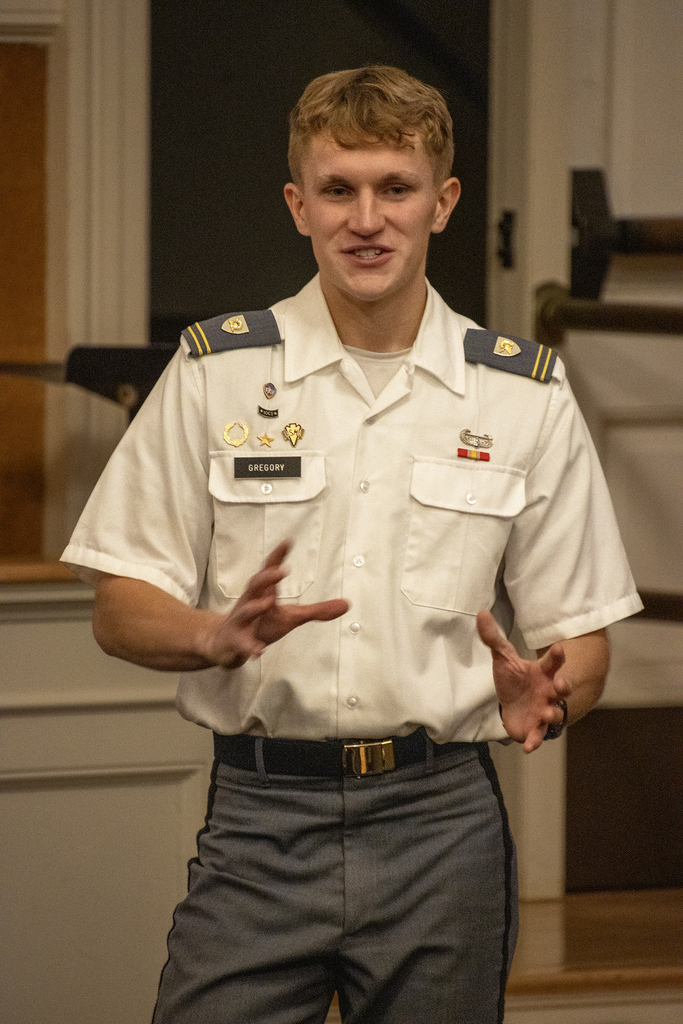 West Point cadet gestures while speaking to students