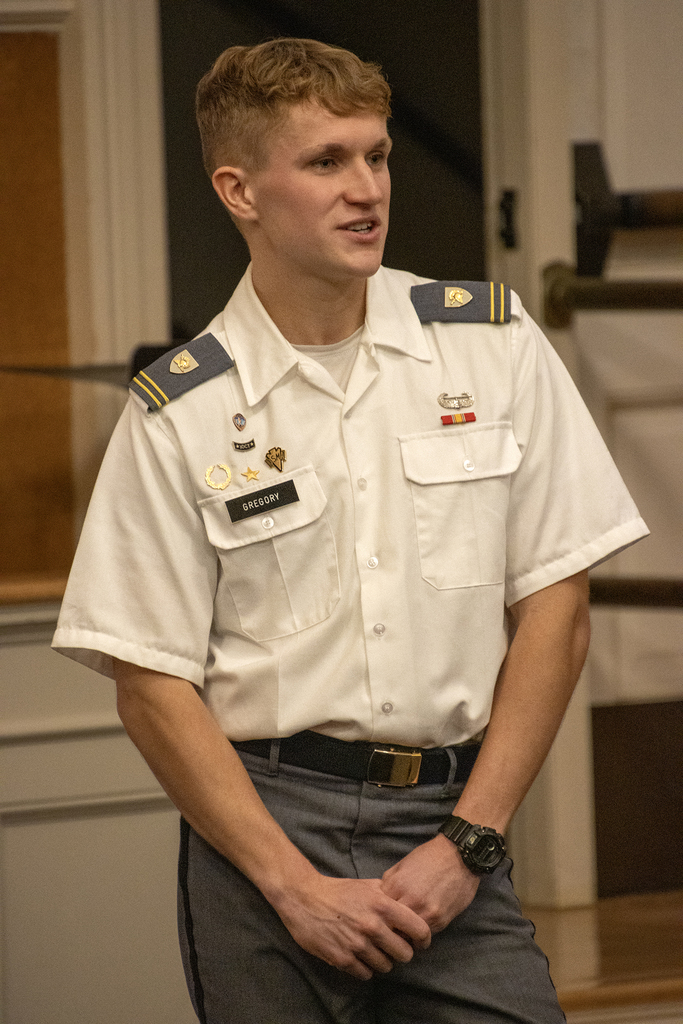 West Point cadet gestures while speaking to students