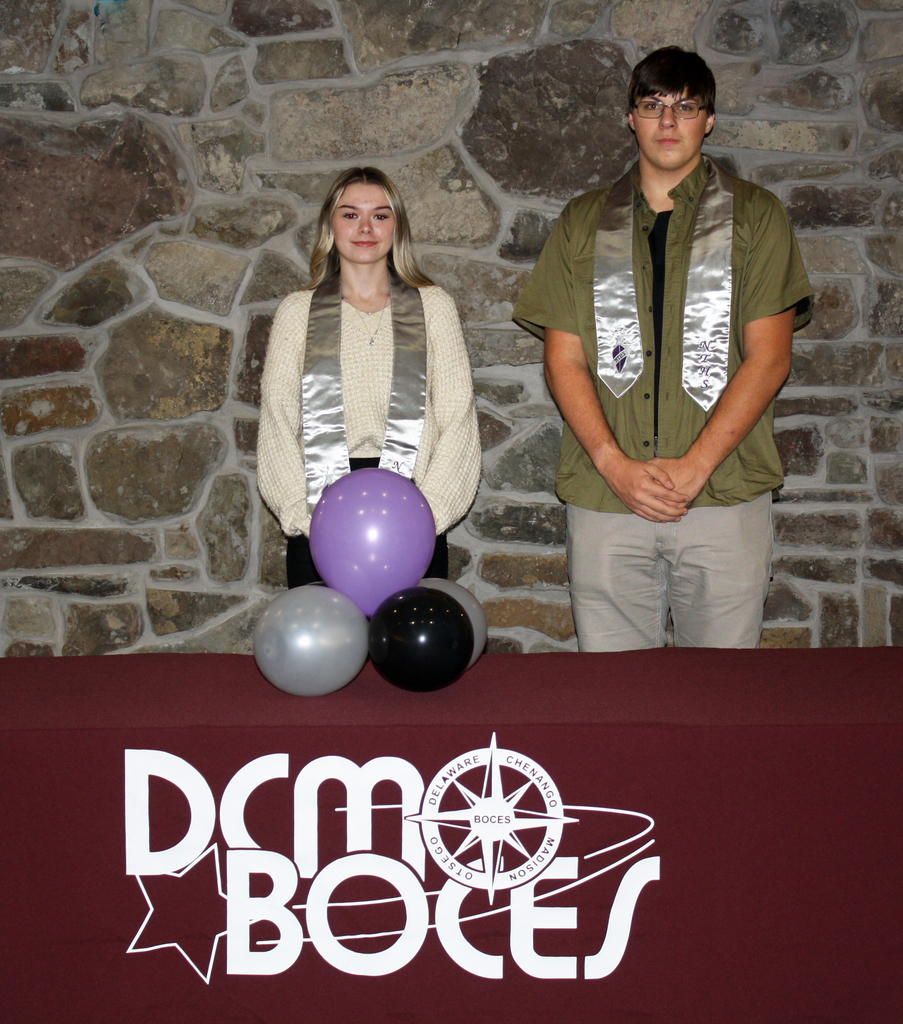 2 students pose behind a DCMO BOCES table