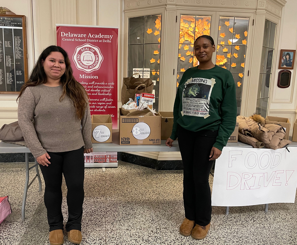 Two SUNY Delhi nursing students pose at the food drive table