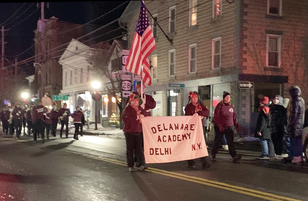 Color guard carrying banner that says Delaware Academy Delhi NY