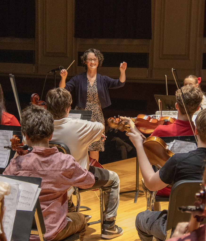 adult conducting middle school orchestra