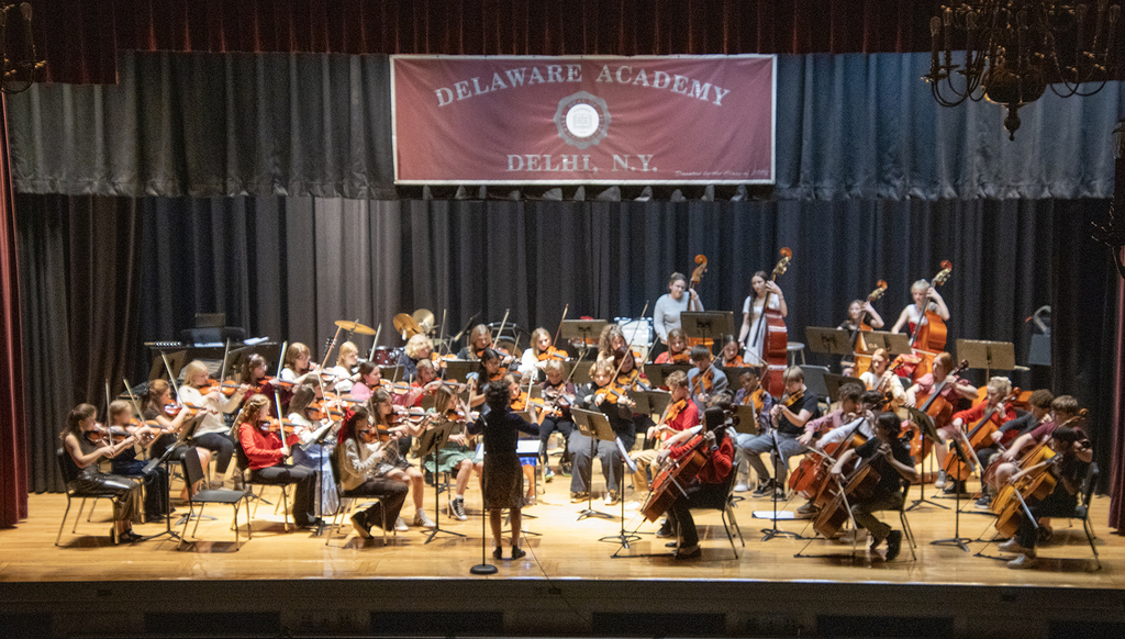 adult conducting middle school orchestra