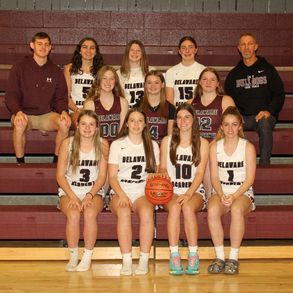 10 girls and two basketball coaches pose for group picture