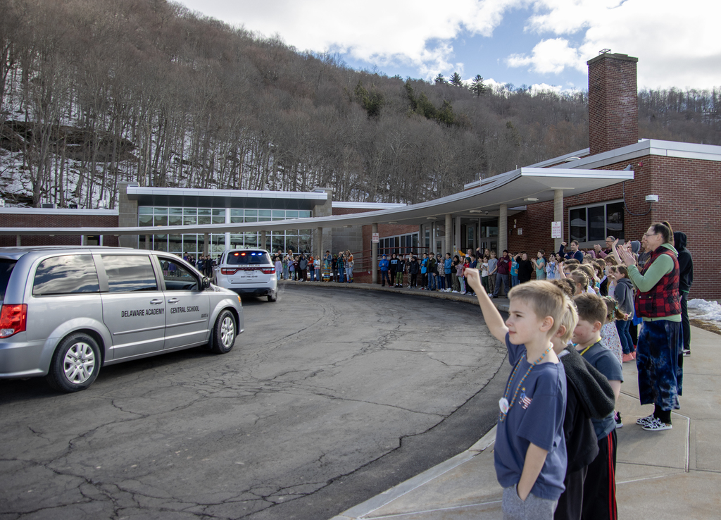 elementary students cheer Cadence Guy's motorcade
