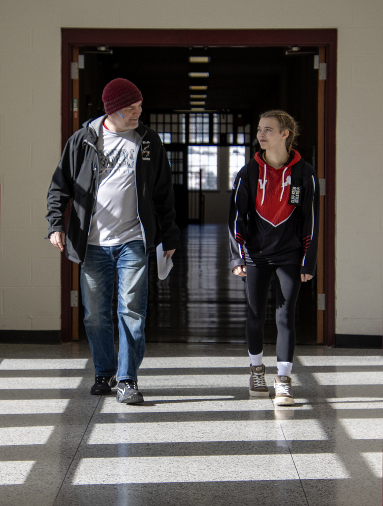 Cadence and Coach smiling in hall