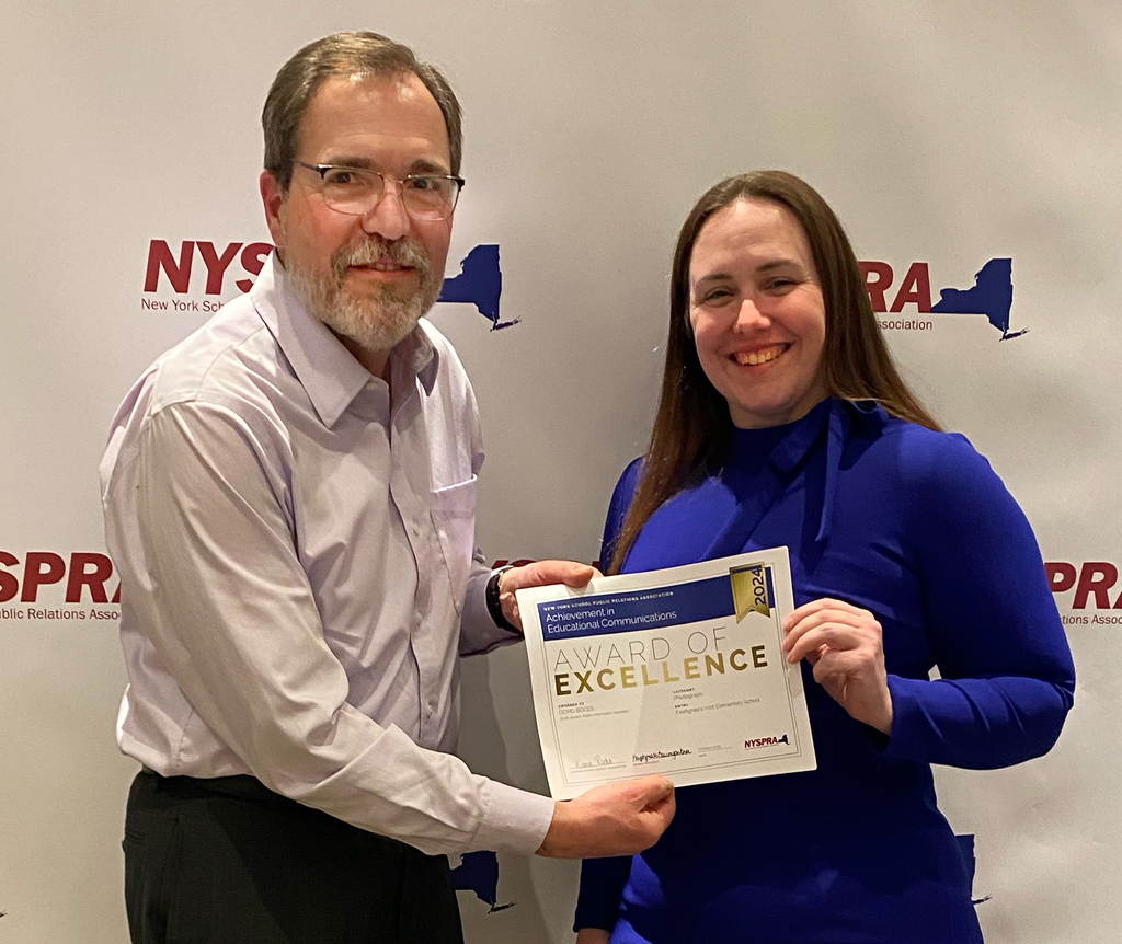 two people pose with a certificate
