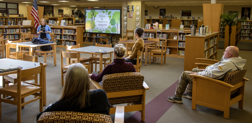 Presenter speaks about Stress Management to a group of adults in the library.