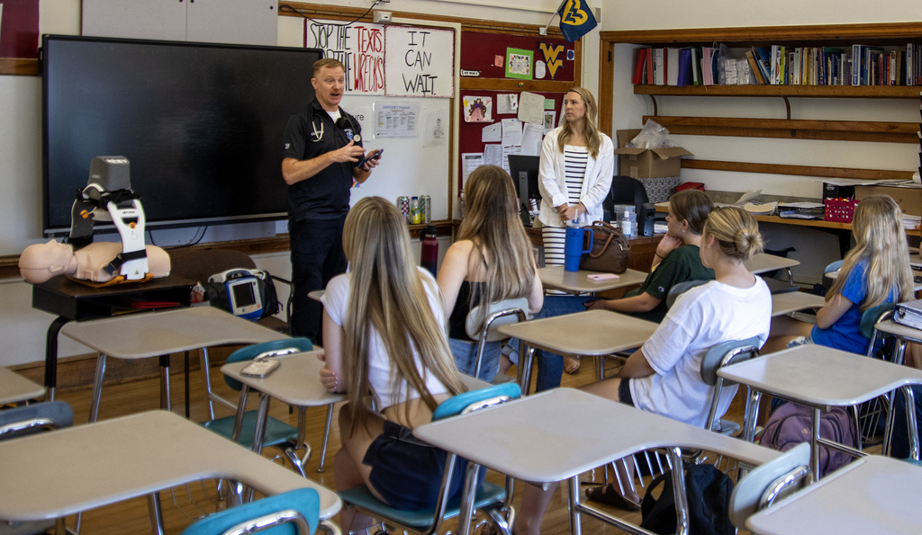 emergency medical provider spekas to students and teacher in class