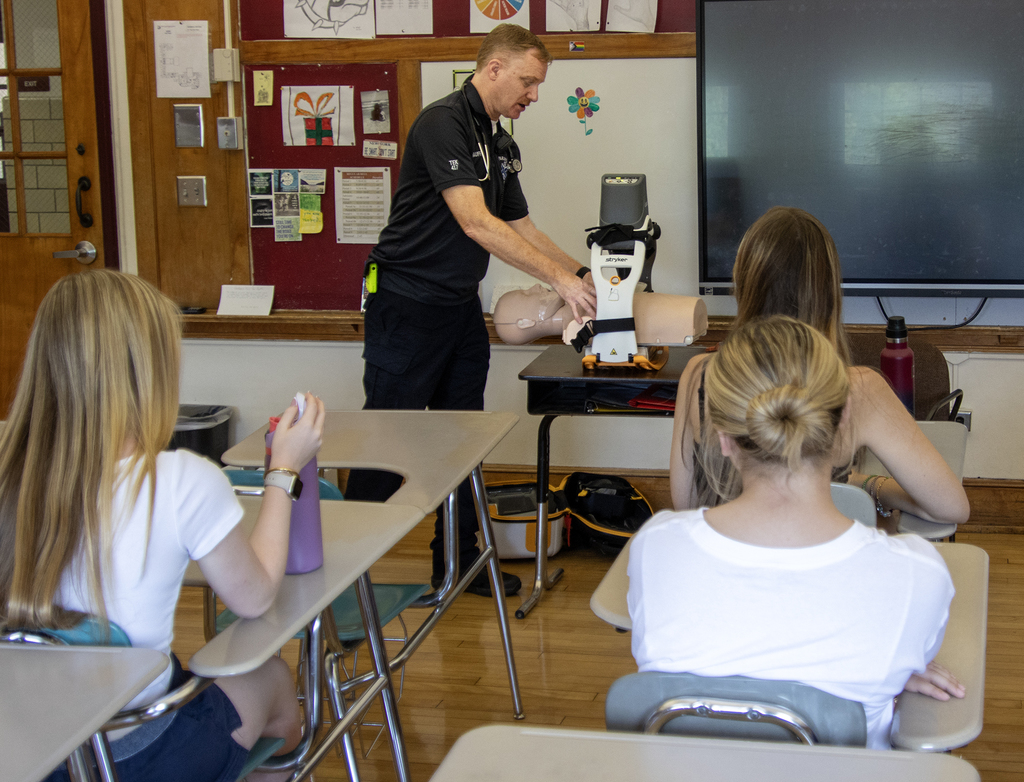 emergency medical provider demonstrates equipment to students in class