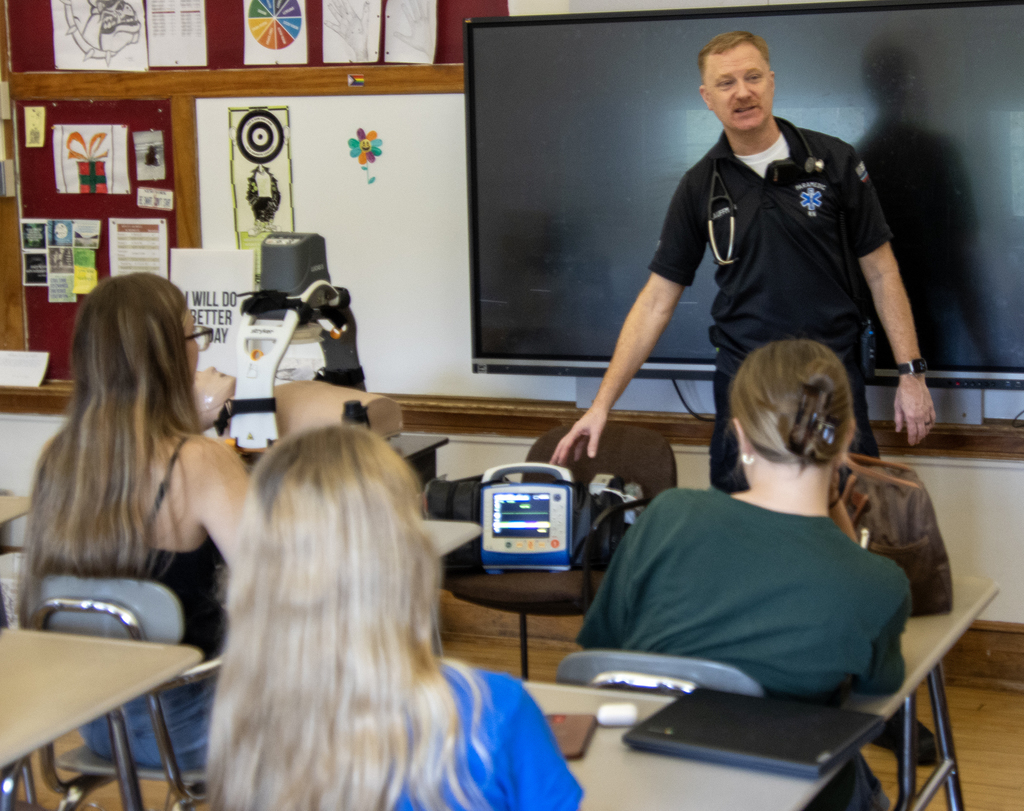 emergency medical provider demonstrates equipment to students in class