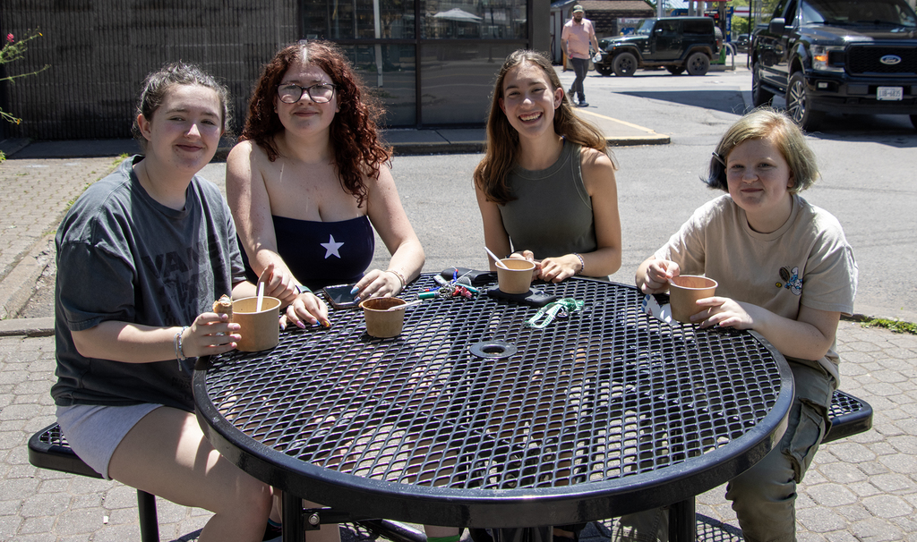 4 girls eating ice cream at table