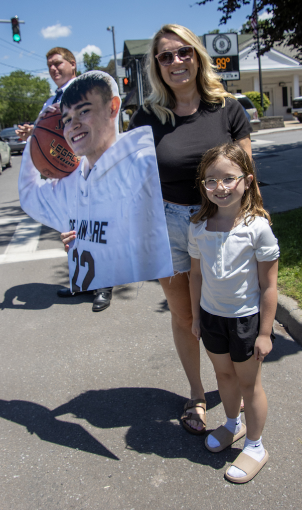 mother and duaghter holding cutout sign of senior