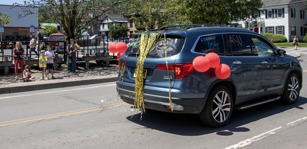 locals applaud the car parade downtown