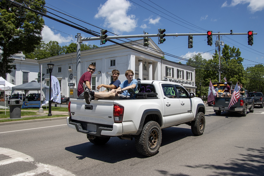 2 decorated trucks; one has 3 duds sitting in the back