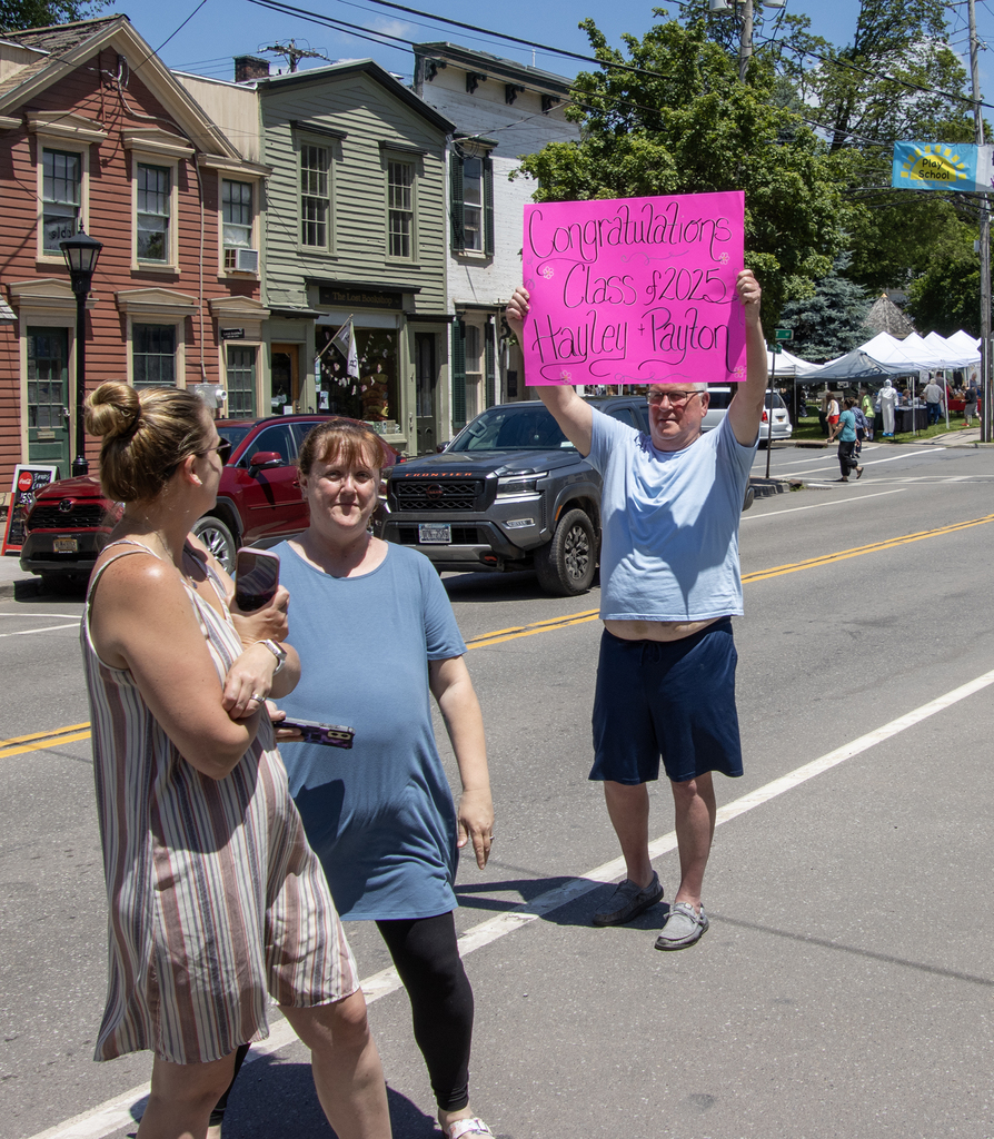 IMG_7227 copyadult holding sign that says Congratulations Class of 2025 Hayley Payton
