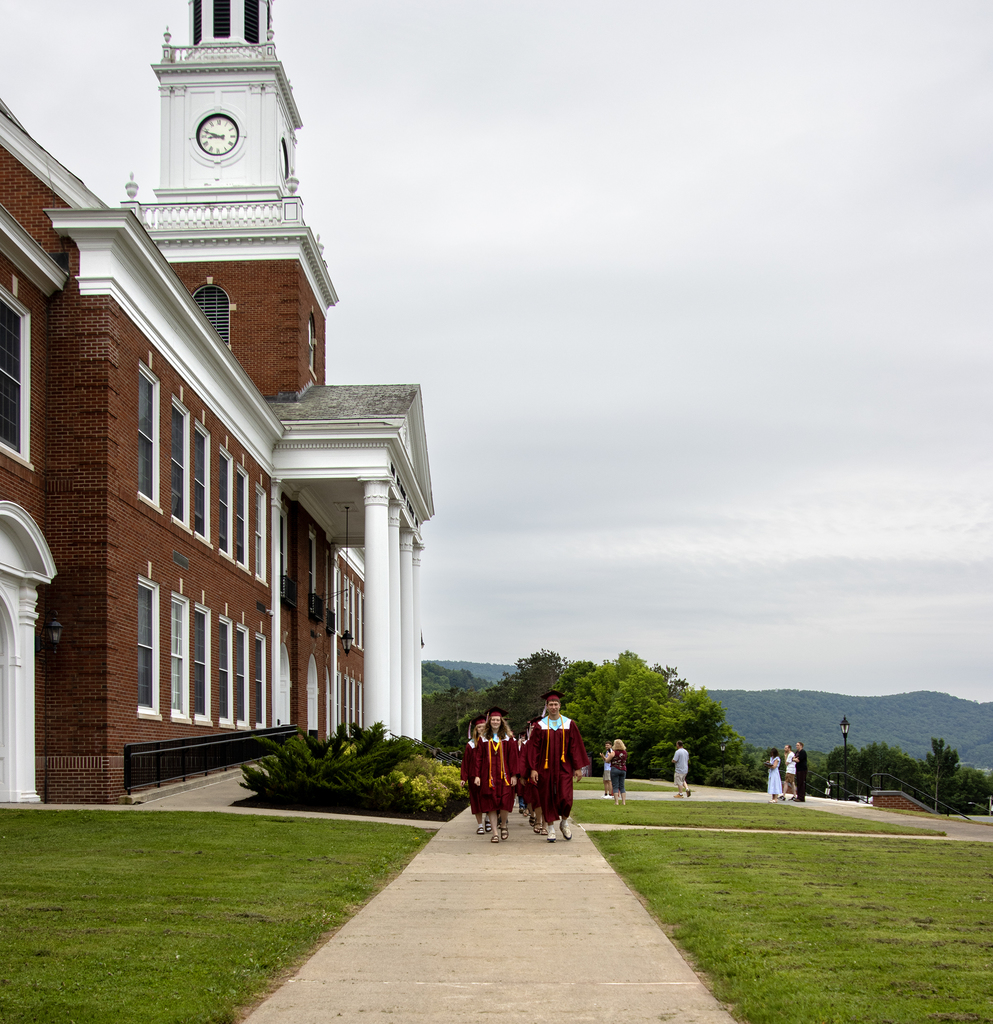 seniors walk in front of school