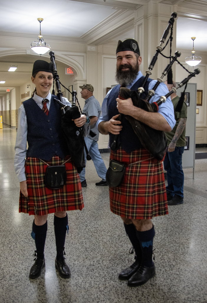 2 smiling bagpipers