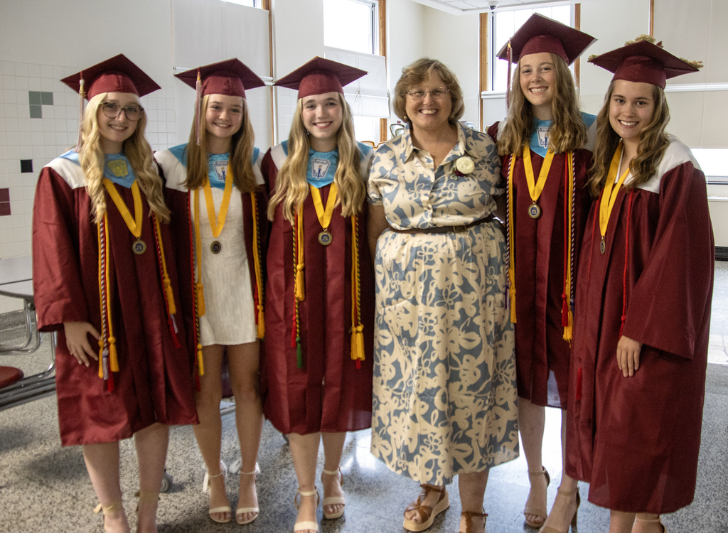 Mrs. Whittaker poses with 5 students
