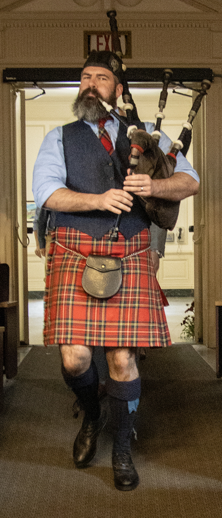 bagpiper enters auditorium