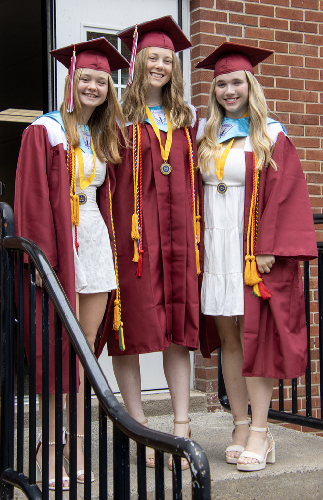 3 girls pose on stairs