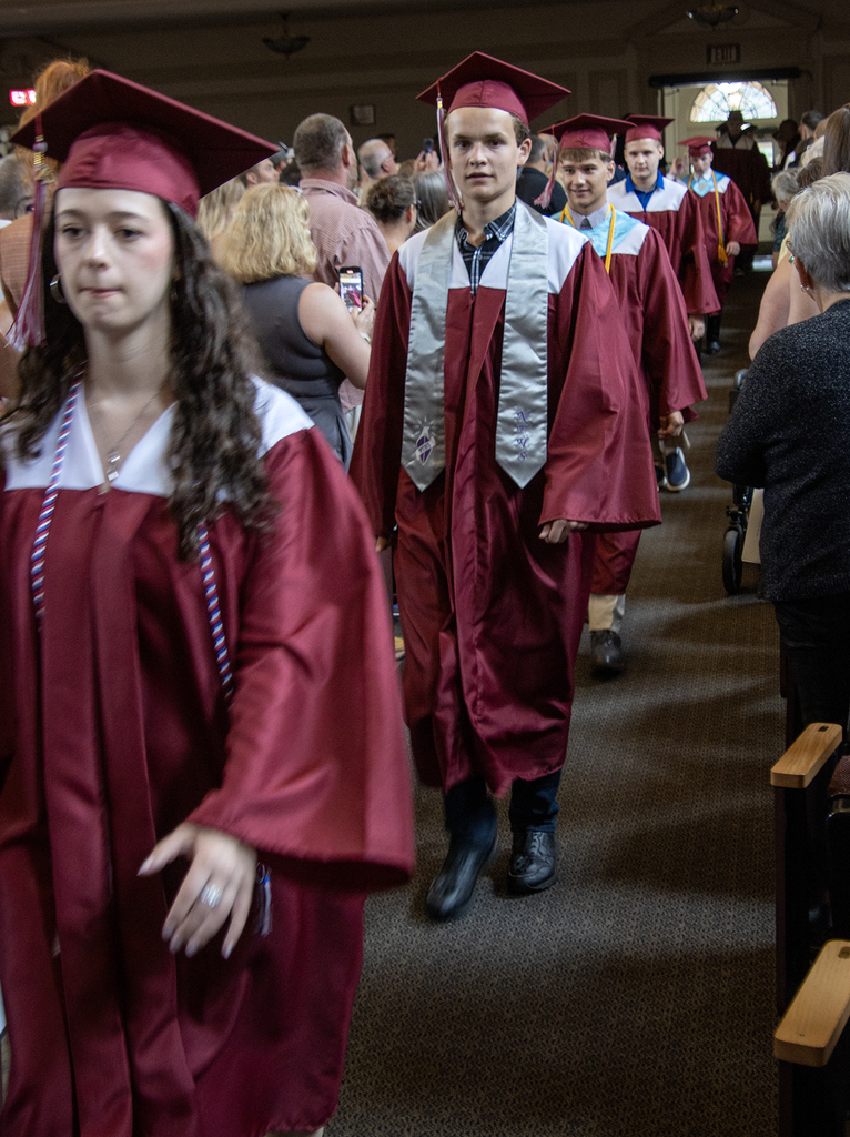 5 students processing in auditorium
