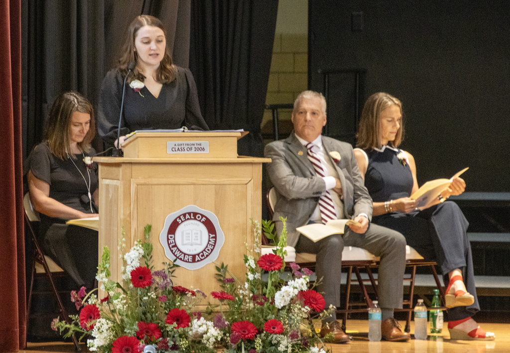 director of special education speaks at lectern, administrators listen