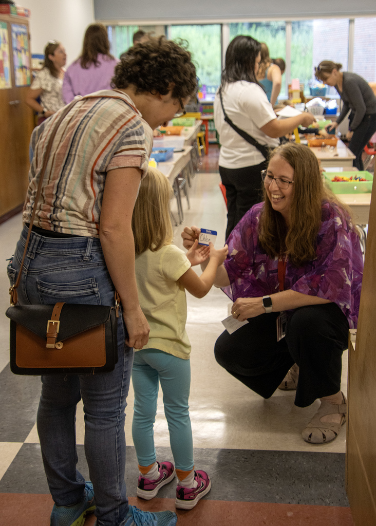 Mrs. Burrows gives a student a nametag