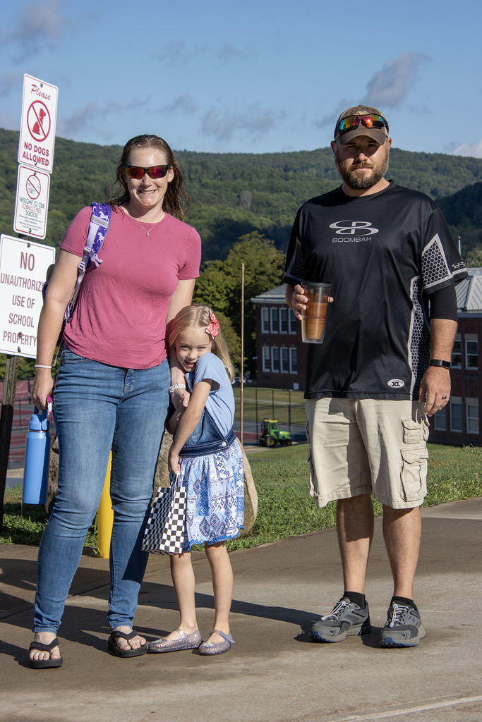 parents and girl outside