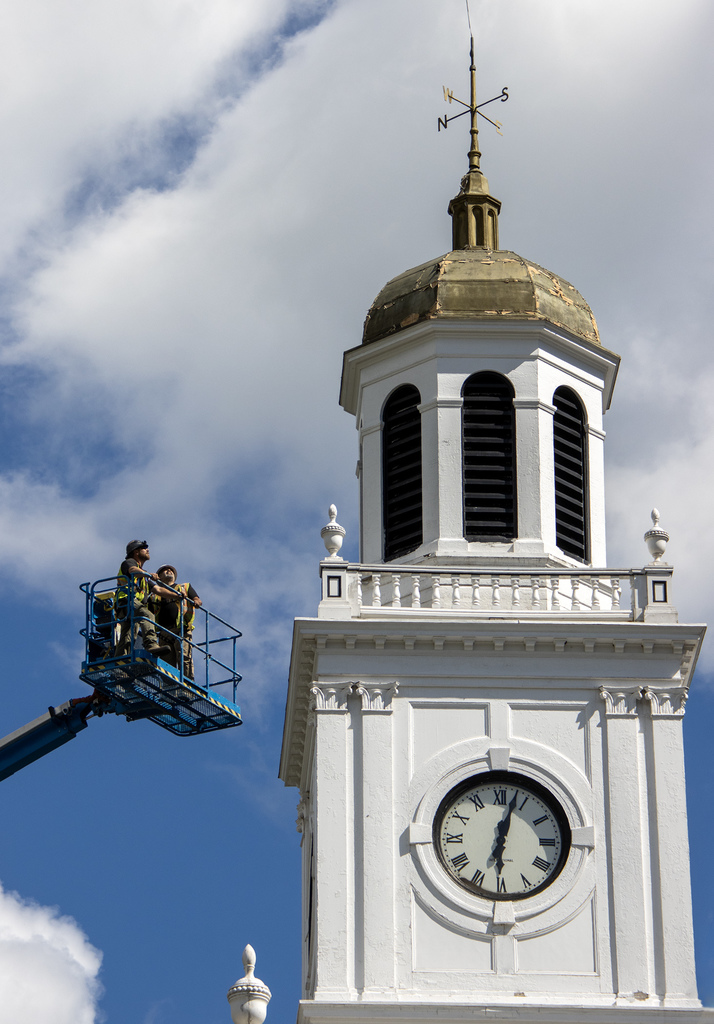 2 workers in a lift look at cupola