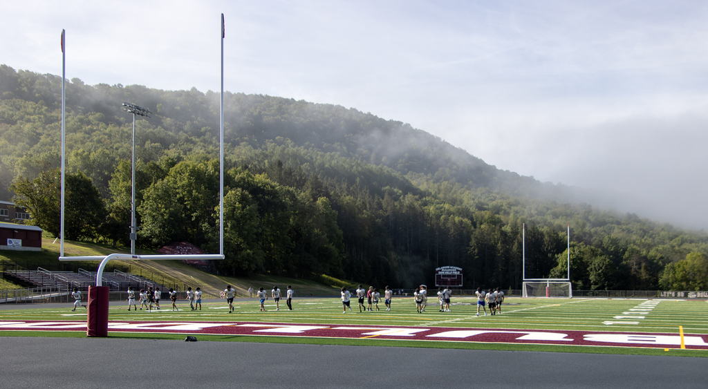 view of goalposts and players practicing