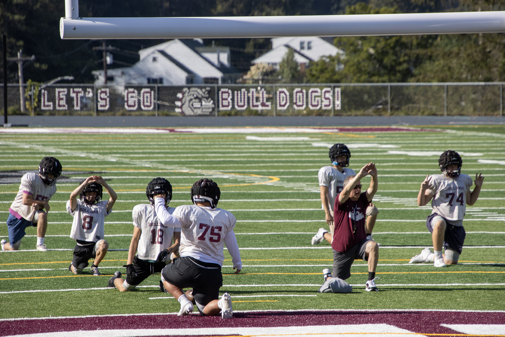 coach leads players through warmups