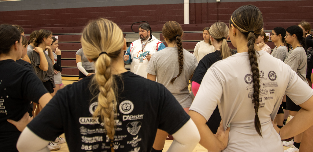 Coach All speaks to volleyball players