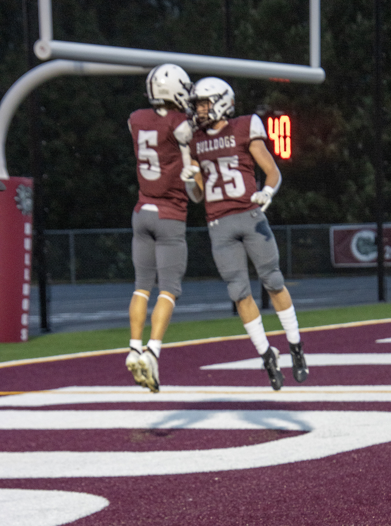 football players celebrating in end zone