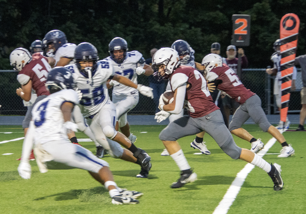 footbal player carrying  the ball
