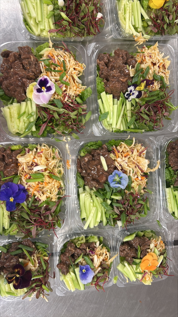 mongolian beef bowls with flower garnishes