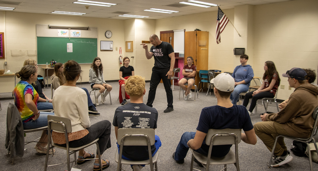 Pat Murphy speaks to a group in a circle
