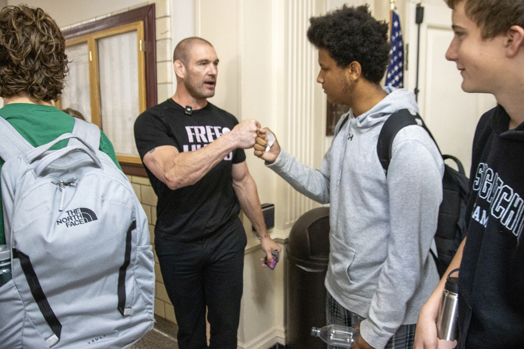 Pat Murphy fist-bumps students