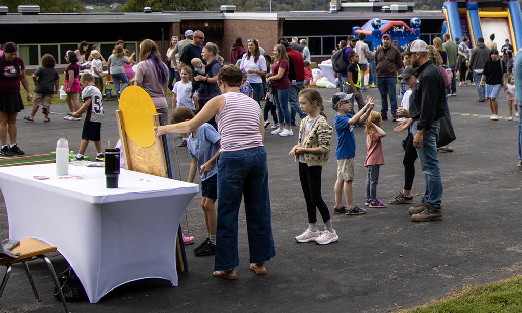 students in line at Plinko game at carnival