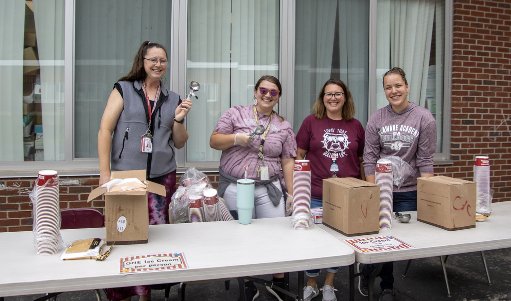 4 adults pose with ice cream scoops