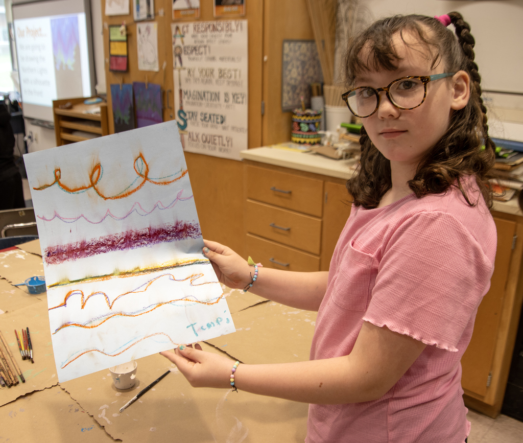 Student poses with her artwork