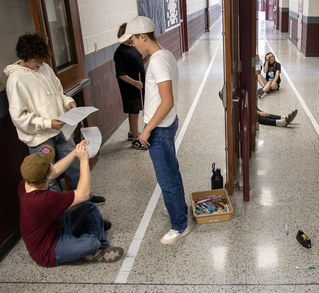 students in hallway working on science project