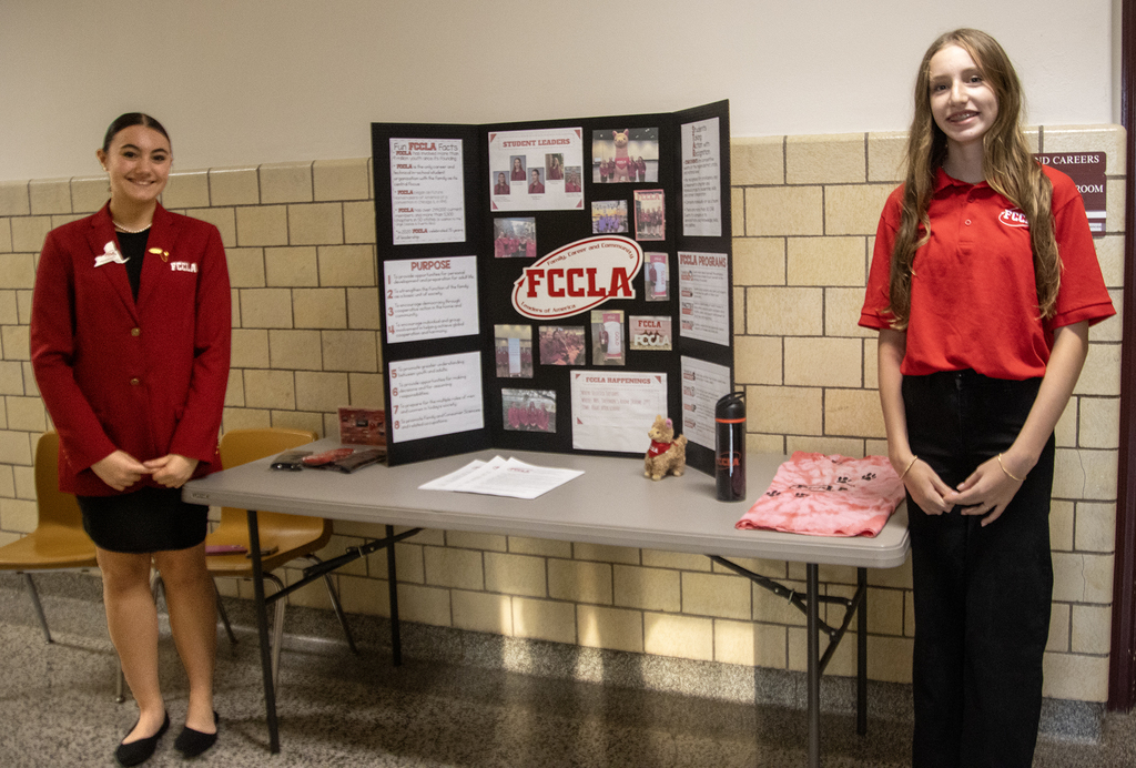 2 students flank an FCCLA display