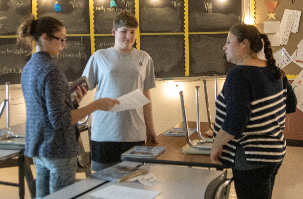 student and mother speak to teacher