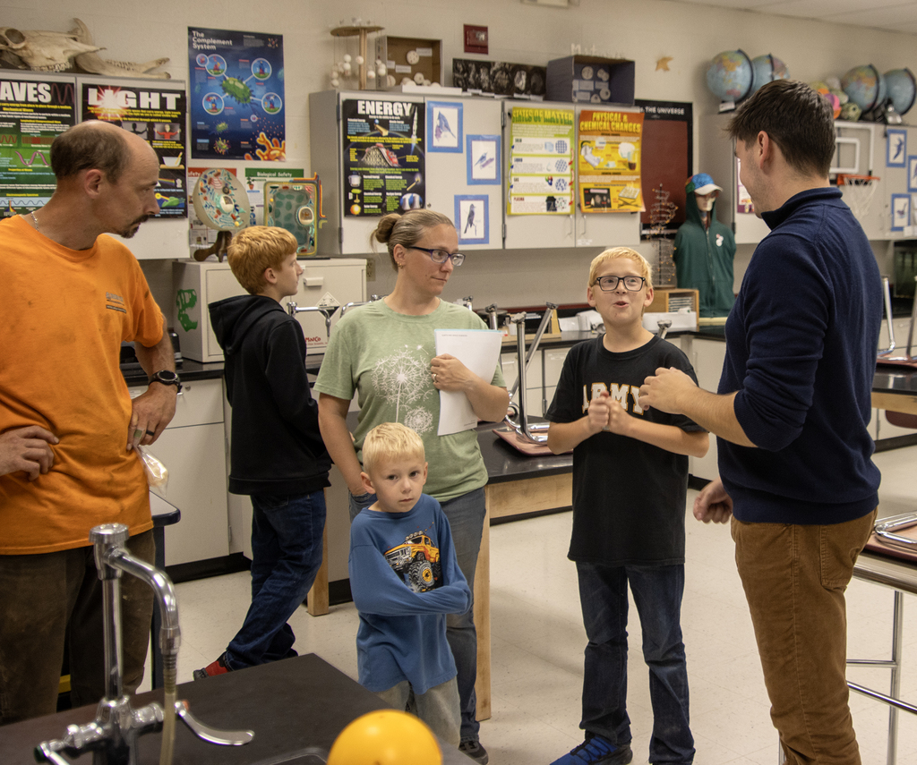 2 adults and 3 children with a science teacher