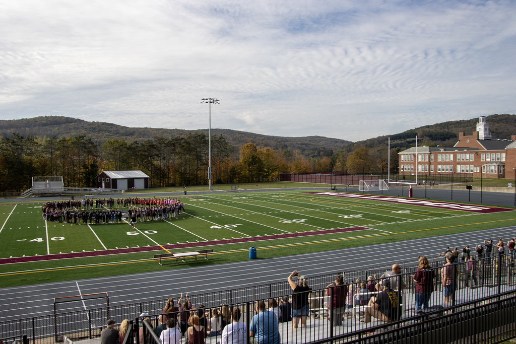 sports teams in big circle on the field