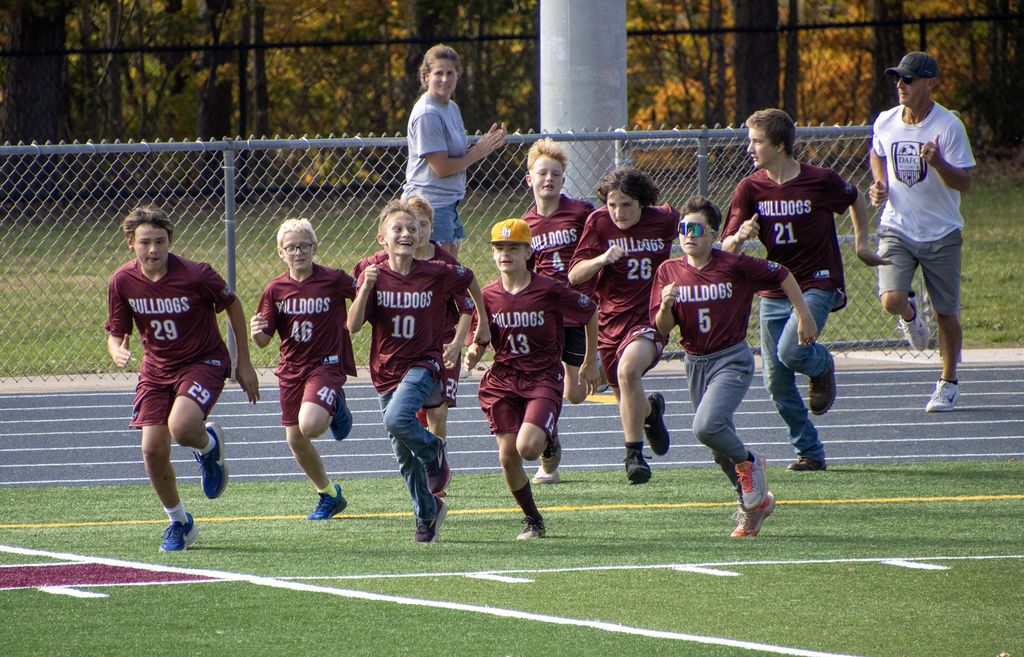 kids run onto field