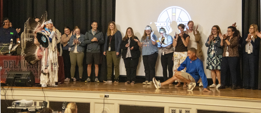 Native American rapper with dancing teachers on stage