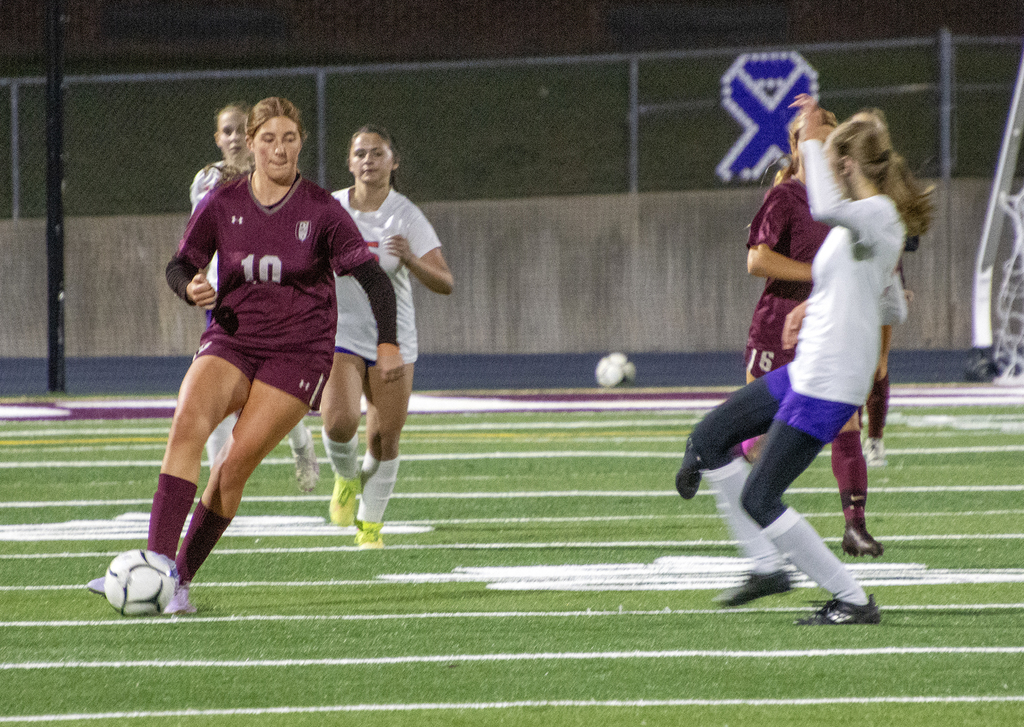 girls varsity soccer in action on the field